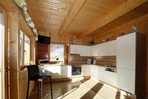 a kitchen with white appliances and a wooden ceiling at House in Zell am Ziller with Panoramic Views in Zell am Ziller