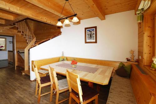 a dining room with a wooden table and chairs at House in Zell am Ziller with Panoramic Views in Zell am Ziller