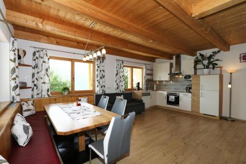 a kitchen and living room with a table and chairs at Chalet in Zell am Ziller near Ski Lifts in Zell am Ziller