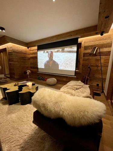 a living room with a flat screen tv and a couch at Standing Megeve - 2 to 8 people - Mont d'Arbois in Megève