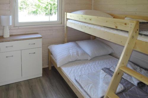 a bedroom with two bunk beds and a desk at Holiday complex, Kolczewo in Kołczewo