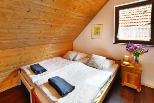 a bed in a room with a wooden wall at Holiday complex, Bobolin in Bobolin