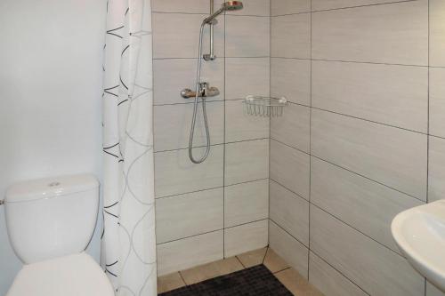 a bathroom with a shower with a toilet and a sink at Holiday homes, Rewal in Rewal