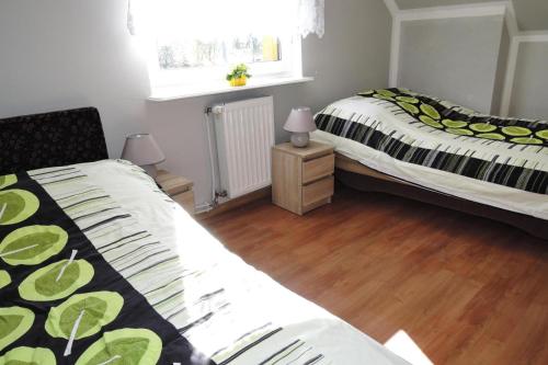 a bedroom with two beds and a window at Holiday home Stepniczka in Stepnica