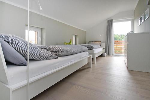 a bedroom with two beds and a window at Holiday home Min Kaat, Nakenstorf in Nakensdorf