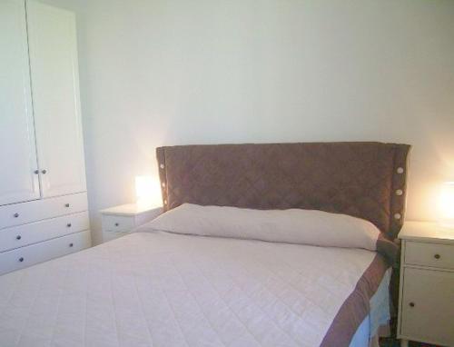 a bed in a bedroom with two night stands and two lamps at Cathy Apartment in Rome