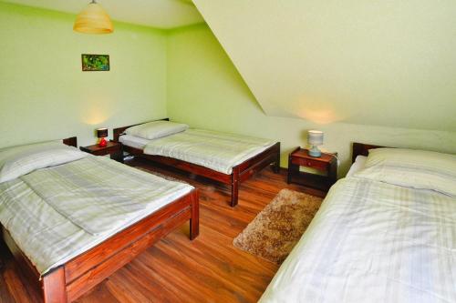 a room with two beds and two tables in it at Holiday resort, Osieki in Osieki