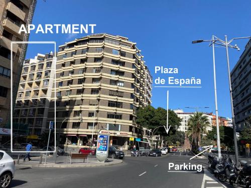 a tall building on a city street with buildings at Olof Apartment in Las Palmas de Gran Canaria