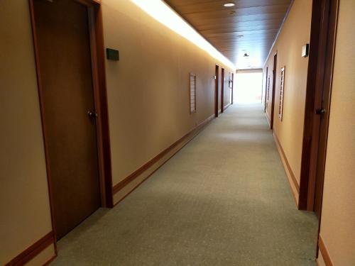 a hallway of an office building with a long corridor at Azumakan in Nihommatsu