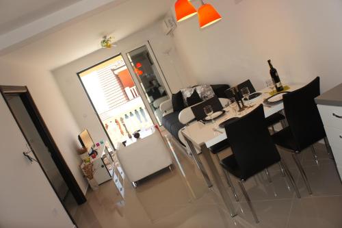 a living room with a table and chairs and a couch at Apartments Adriatico in Herceg-Novi