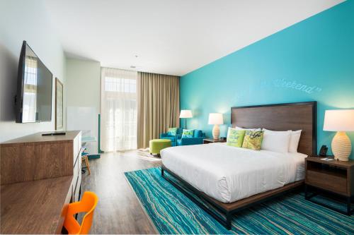 a hotel room with a bed and a desk at The Lodge at Camp Margaritaville in Pigeon Forge