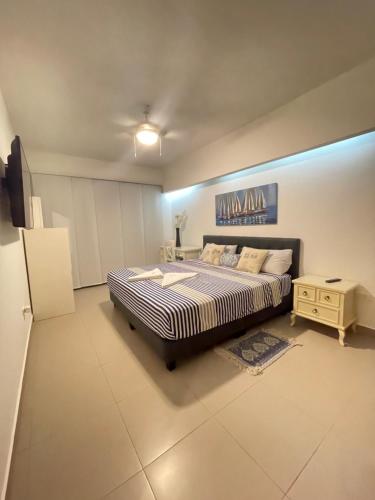 a large bedroom with a bed and a night stand at Departamentos frente al mar in Tonsupa