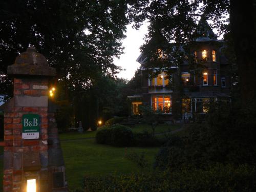 a large house with a sign in front of it at B&B Villa Emma in Ghent