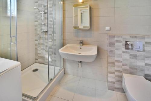 a white bathroom with a sink and a shower at Holiday resort, Sianozety in Sianozety