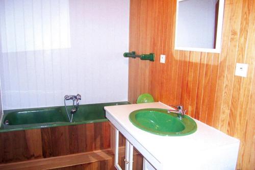 a bathroom with a green sink and a tub at Granite stone house with fireplace, Plouguerneau in Plouguerneau