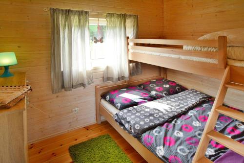 a bedroom with two bunk beds and a window at Holiday resort, Jaroslawiec in Jarosławiec