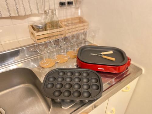 a keyboard and a clock sitting on top of a sink at Yoyogi Apartment 2-401 in Tokyo