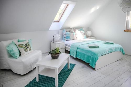 een slaapkamer met een bed, een bank en een stoel bij Comfortable holiday home with a private garden in Debina