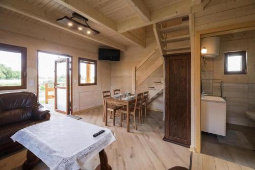 a living room and dining room of a tiny house at Holiday resort, Wicie in Wicie