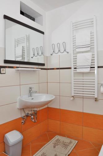 a bathroom with a sink and a toilet at Apartments Crobeg in Rab