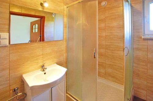 a bathroom with a shower and a sink and a mirror at Terraced Houses, Sarbinowo in Sarbinowo