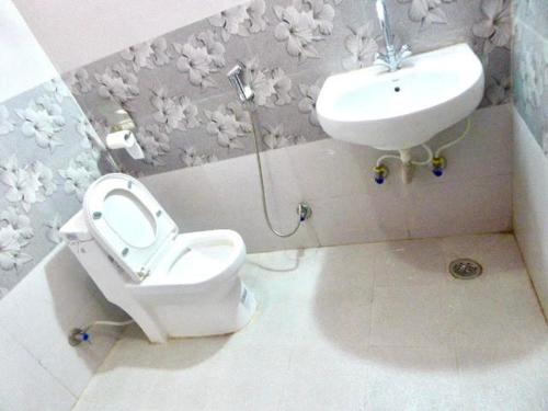 a bathroom with a toilet and a sink at Hotel Grace in Pokhara