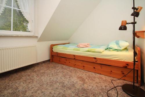 a small bedroom with a bed in a attic at Apartments, Mirow in Mirow