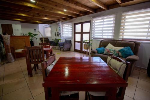 a living room with a table and a couch at Hotel Tierra de Parras in Chillán