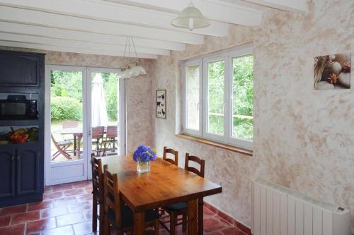 a dining room with a wooden table and chairs at Holiday Home near Rosa Granite Coast Beaches in Langoat