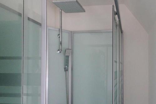 a shower with a glass door in a bathroom at Holiday Home near Rosa Granite Coast Beaches in Langoat