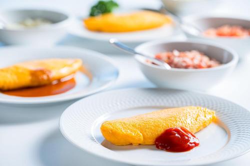 a white plate with a piece of food on a table at ANA Crowne Plaza Matsuyama by IHG in Matsuyama