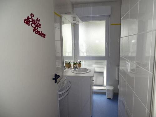 a white bathroom with a sink and a window at Studio, Audierne in Audierne