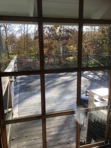 a view of a deck from a window at Idyllic bungalow close to sea and forest - Self contained in Ronneby