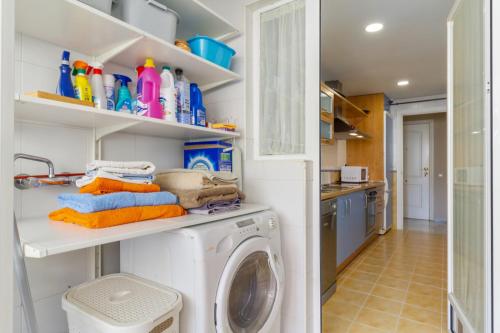 a laundry room with a washer and dryer at Benalmadena with seasonal pool & parking near the beach in Arroyo de la Miel