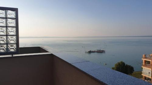 a view of a large body of water with a boat at Galerius Golden Beach Apartment in Siófok