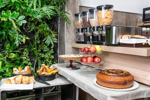 a table with bread and cakes and other food on it at Hotel Paolo II in Rome