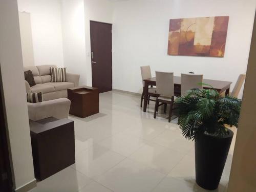 a living room with a couch and a table at Departamento a 200 Mts de la playa y alberca en planta baja in Mazatlán