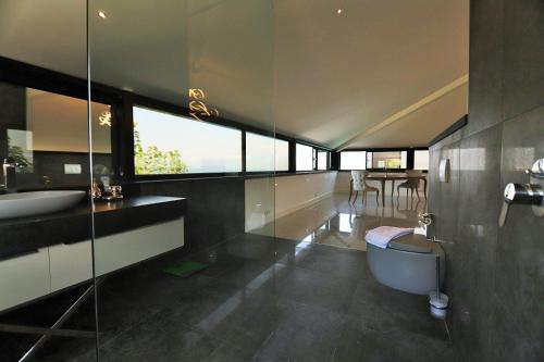 a bathroom with a tub and a toilet and a sink at Casa Blanca in Fethiye