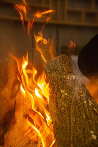a fire is burning in a fire pit at Adryades luxury apartments in Metsovo