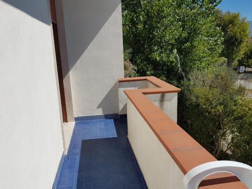 a balcony with a bench on the side of a building at CASA GIOVANNA CASAL VELINO in Casal Velino
