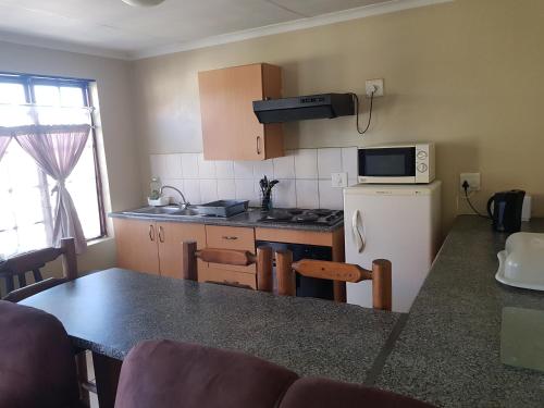a kitchen with a counter top and a refrigerator at Louhallas Accommodation in Edenvale