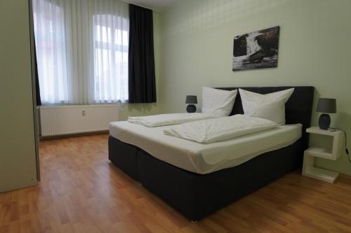 a bedroom with a large bed with white pillows at Otto der Reiche in Ballenstedt