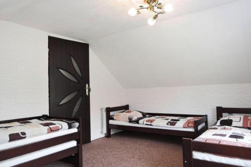a bedroom with two beds and a ceiling at Holiday complex, Swinoujscie in Świnoujście