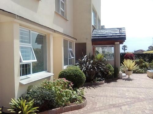a house with a brick walkway in front of it at Access Guest House in Summerstrand