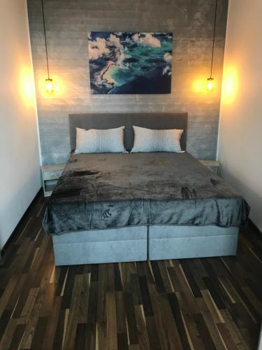 a bedroom with a large bed with two pillows at Modernes wohnen im alten Beelitz Wohnung 2 in Beelitz