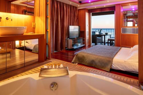 a bathroom with a tub and a bedroom with a bed at Rabelais in Cannes