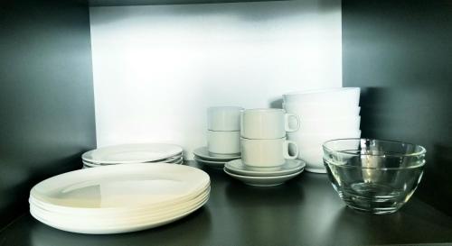 uma mesa preta com pratos e um copo sobre ela em Areg's house, warm apartment in Kechi house em Tsaghkadzor