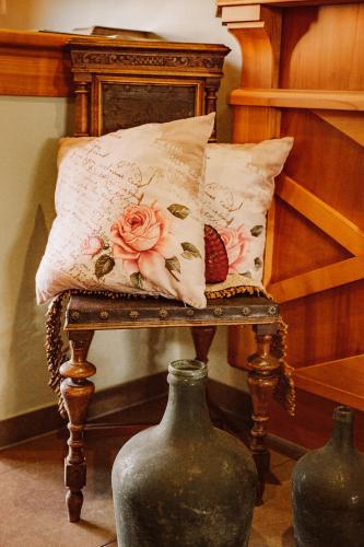 a chair with a pillow on it with two vases at Weingut Kollerhof am Eichberg in Leutschach