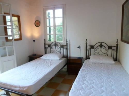 a bedroom with two beds and a window at Villa Angela, Panoramablick übers Meer in Vasilikos