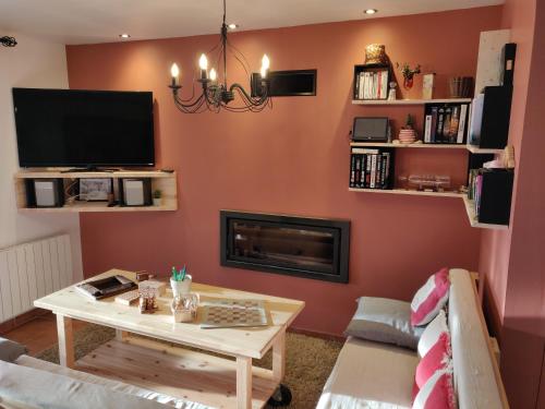 a living room with a table and a fireplace at Les Terrasses de Valensole in Valensole